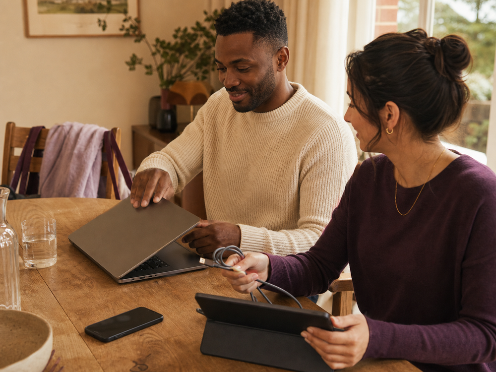 A couple gather their laptop, tablet and charging cable before heading out.